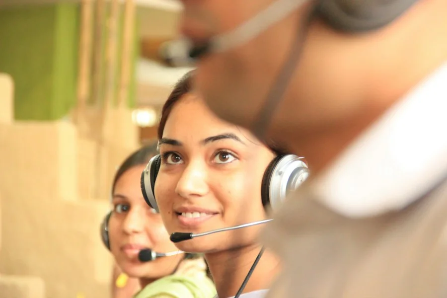 Smiling woman wearing a headset in a bright office