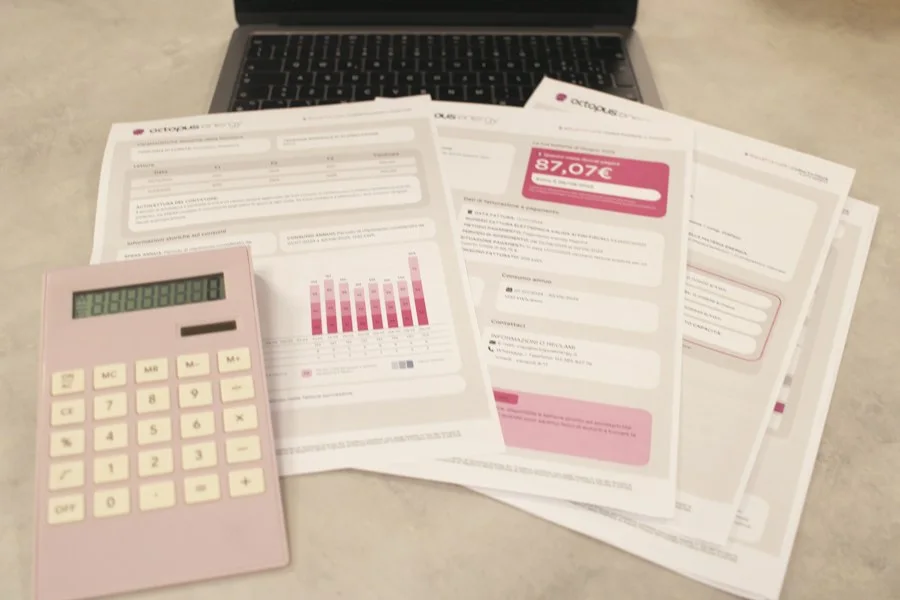 Bills and a calculator laid out on a desk